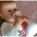 girl drinking warmed milk with iiamo go baby bottle