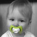baby with beloved iiamo soother in green