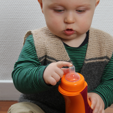 toddler with his iiamo drinking bottle and iiamo flow teat